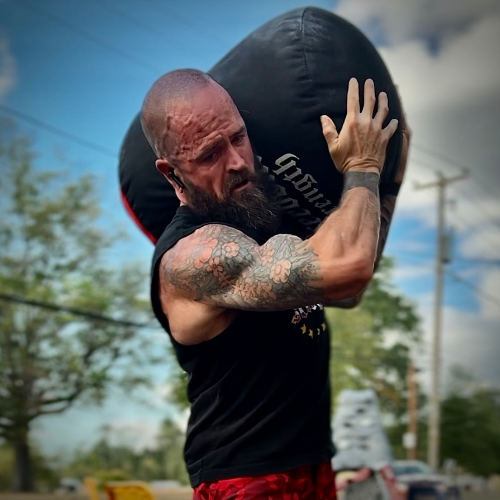 Freedom Strength strongman sandbag being shouldered by a dad at home